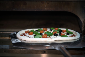 Homemade pizza with tomatoes, mozzarella and basil.