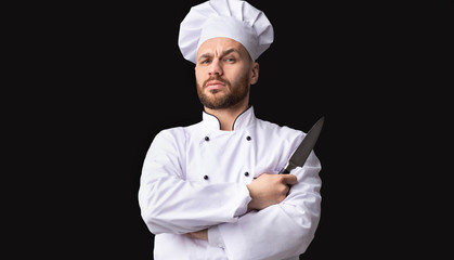 Serious Chef Holding Knife Looking At Camera Posing, Studio Shot