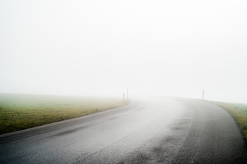 Foggy road to nowhere on a cold autumn day