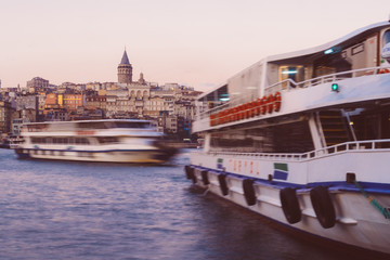 Istanbul, Turkey - Jan 15, 2020: Galata Tower with Ferry Boat in Golden Horn , Istanbul, Turkey,