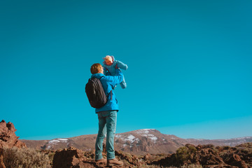 father with little baby enjoy travel in mountains