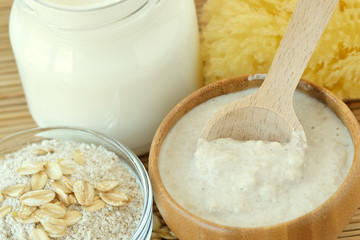 Homemade yogurt and oatmeal face mask in wooden bowl with spoon