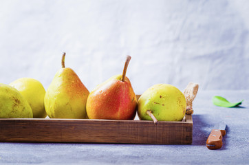 Fresh organic ripe pears on wooden   board.