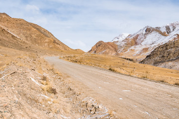 the gravel road on the snow mountain