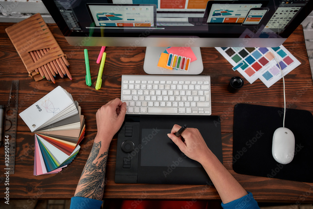 Wall mural professional web illustrator. top view of a graphic designer using graphic tablet and computer in th