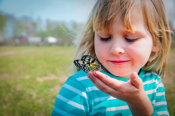 little girl looking at butterfy, kids learning nature