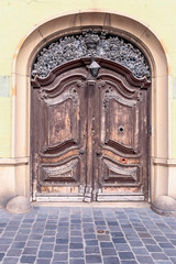 old wooden door with metal ornaments in the historical part of Budapest