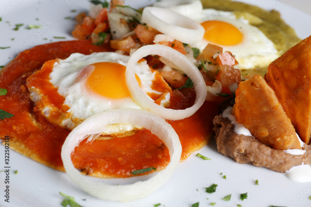 Canvas Prints Huevos divorciados, fried eggs on corn tortillas with salsa verde and roja, mexican breakfast