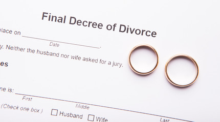 Divorce decree and two wedding rings, background - obrazy, fototapety, plakaty