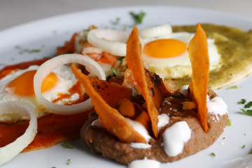 Huevos divorciados, fried eggs on corn tortillas with salsa verde and roja, mexican breakfast 