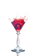 glass with red splash isolated on white