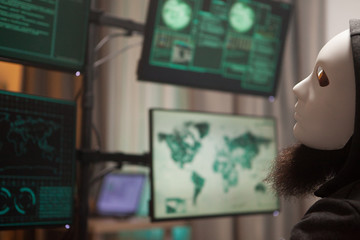 Hacker wearing a white mask to protect his identity