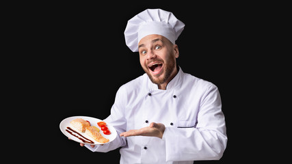 Excited Male Chef Serving Salmon Steak Standing In Studio, Panorama