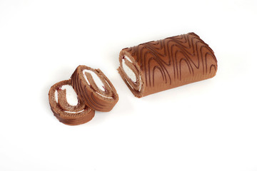 Sliced chocolate biscuit roll cake isolated on white background.
