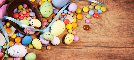 Colorful Easter candies on a rustic wood background