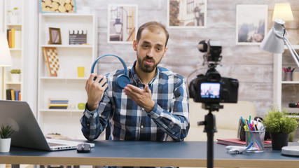 Famous influencer recording a review of a cool headphones
