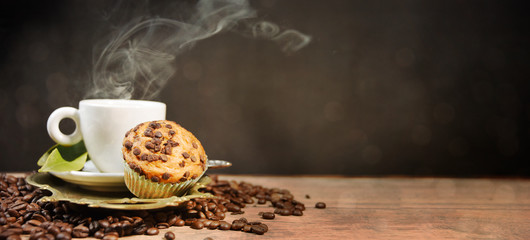 Coffee cup and beans on old kitchen table.