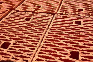 Obraz na płótnie Canvas Textured red building brick close-up