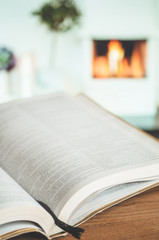 Fototapeta premium Bible on a background of home interior. The concept of faith, spirituality and religion.