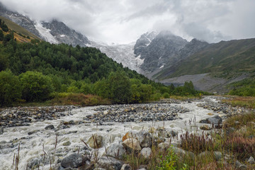 Fototapeta na wymiar Ice river Adishi and glacier Lardaad on background in mountains of Svaneti Georgia
