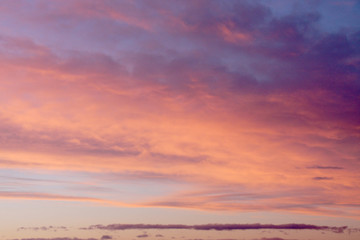 Fototapeta na wymiar Dreamy evening sky in pastel tones with fluffy pink orange clouds at sunset