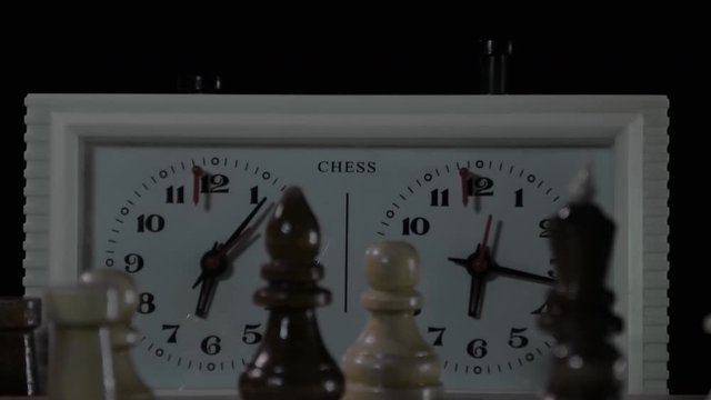 the chess clock is working in the background of unfocused blurred static chess timelapse