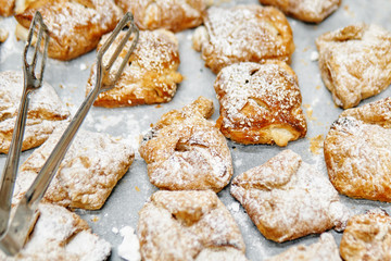 Sweet tasty israeli bakery products with metallic tongs being selled on the street market in Haifa