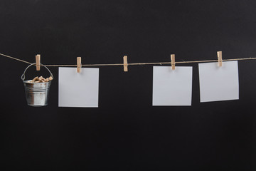 blank photos hanging on a clothesline