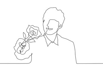 young man in a shirt holds out a rose to the viewer and smiles. One continuous line. Drawing of an attractive man giving a flower. Vector illustration of a man with a gift.