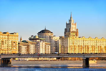 Classic moscow city russia architecture landmark old stalin empire style building on river embankment with british embassy ministry of foreign affairs against sunset sky background. Street wide view