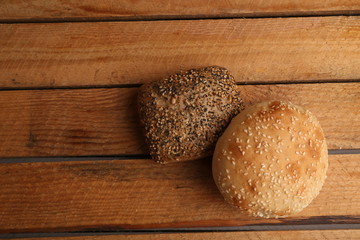 delicious bread rolls on colored background