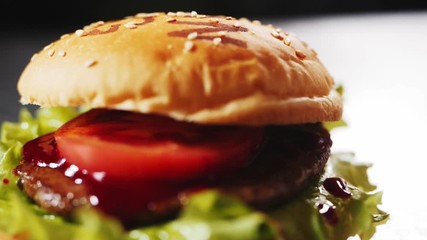 making hamburger with meat patty and tomato on table closeup