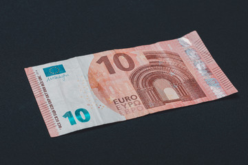 European denomination of ten euros on black background.