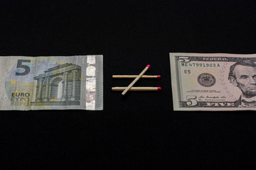On a black background comparing the euro and the dollar.