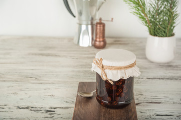 Natural organic jam from pine cones in a jar close-up. Organic jam for health and copy space.