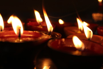 bunch of Oil Diyas with Dark background in a plate
