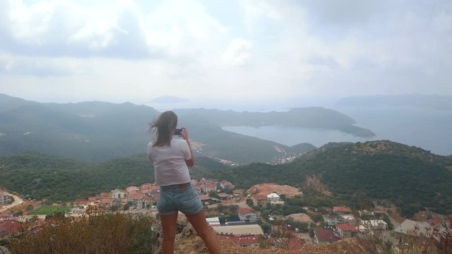 Woman traveller take photos with smartphone