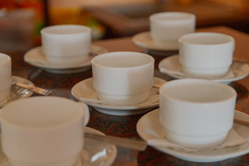 White cups for coffee on the table.
