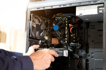 Technician with a screwdriver for fixing computers, computer har;