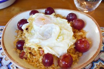 traditional plate of migas with egg and grapes