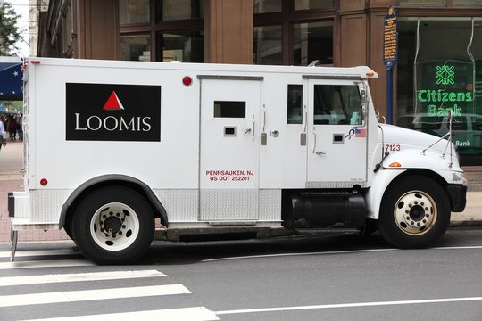 PHILADELPHIA, USA - JUNE 11, 2013: Loomis armored money truck in Philadelphia, USA. Loomis is a cash handling company operating 3,000 money vehicles in the US.
