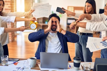 Group of business workers working together. Partners stressing one of them at the office