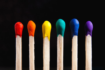 LGBT, protection of human rights concept. Multicolored matches in the colors of the flag of sexual minorities against the blank dark background. Diversity and Inclusion concept