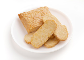 Tempeh delicatessen on plate, isolated on white