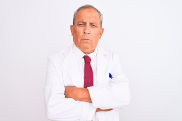 Senior grey-haired scientist man wearing coat standing over isolated white background skeptic and nervous, disapproving expression on face with crossed arms. Negative person.