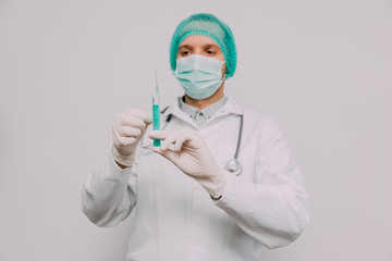 Male doctor with syringe and stethoscope.  Coronavirus epidemic concept.
