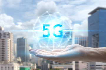 hand holding network using 5G technology with virtual screen on the city background, Technology Internet 5G global network concept.