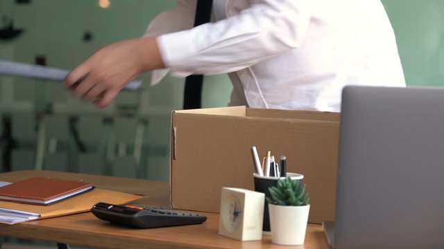 4k video of elegant attractive business man packing personal company belongings resigning from his job changing work in future, Unemployed Business person concept.