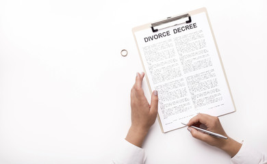 Fototapeta premium Woman signing Divorce decree on white background