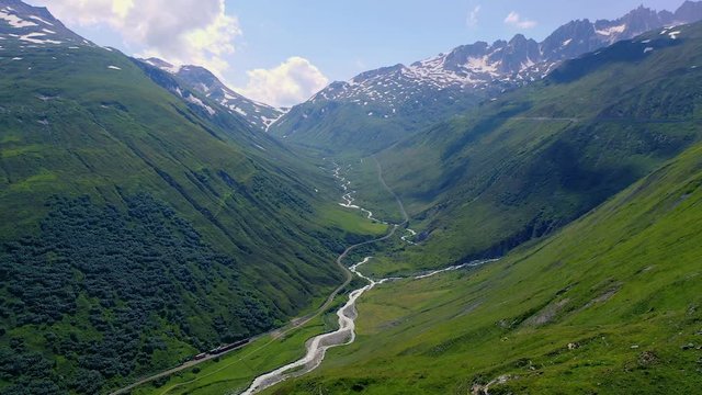 Flying over Urseren valley and the Reuss river in the Swiss Alps, Switzerland